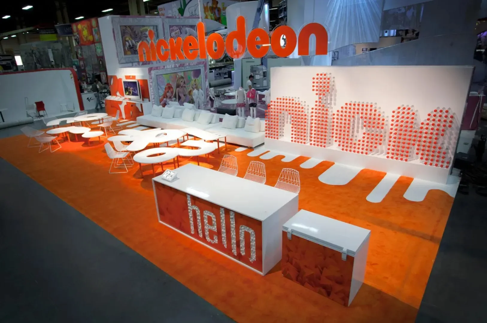 Nickelodeon booth: giant white lettering on bright orange carpet